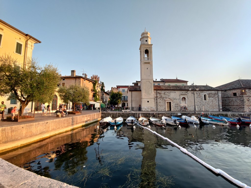 Il porticciolo di Lazise sul Lago di Garda illuminato dalla luce del tramonto, Veneto