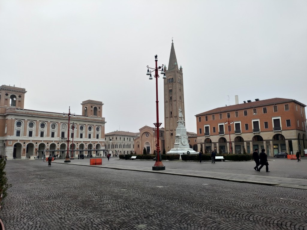 Piazza Saffi a Forlì con la statua del patriota Saffi al centro, l'Abbazia di San Mercuriale e il Palazzo delle Poste