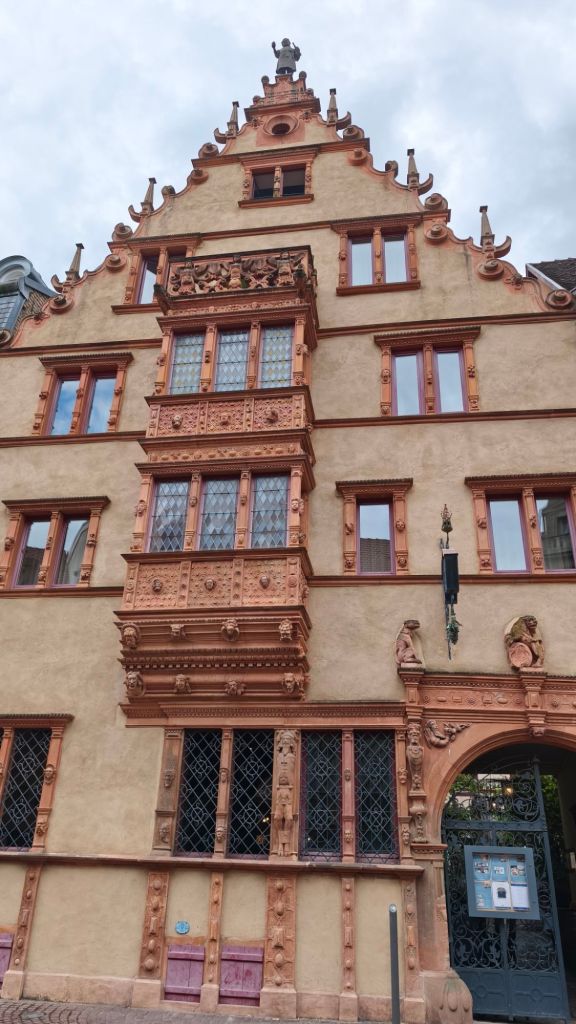 La Maison des Têtes e la statua del bottaio di Bartholdi sulla cima. Colmar, Alsazia, Francia
